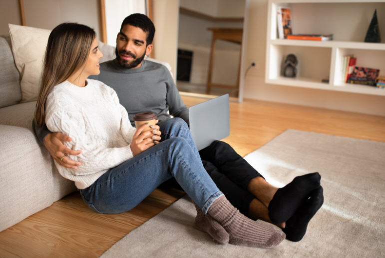 Adult woman sitting calmly in a quiet indoor space, appearing thoughtful and attentive to her body, representing awareness of intimate health symptoms