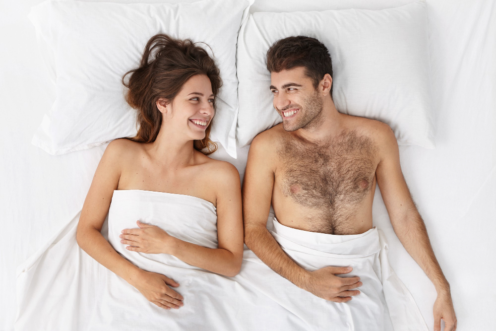 A couple in a quiet post-intimacy moment, emphasizing emotional dynamics over physical pleasure.